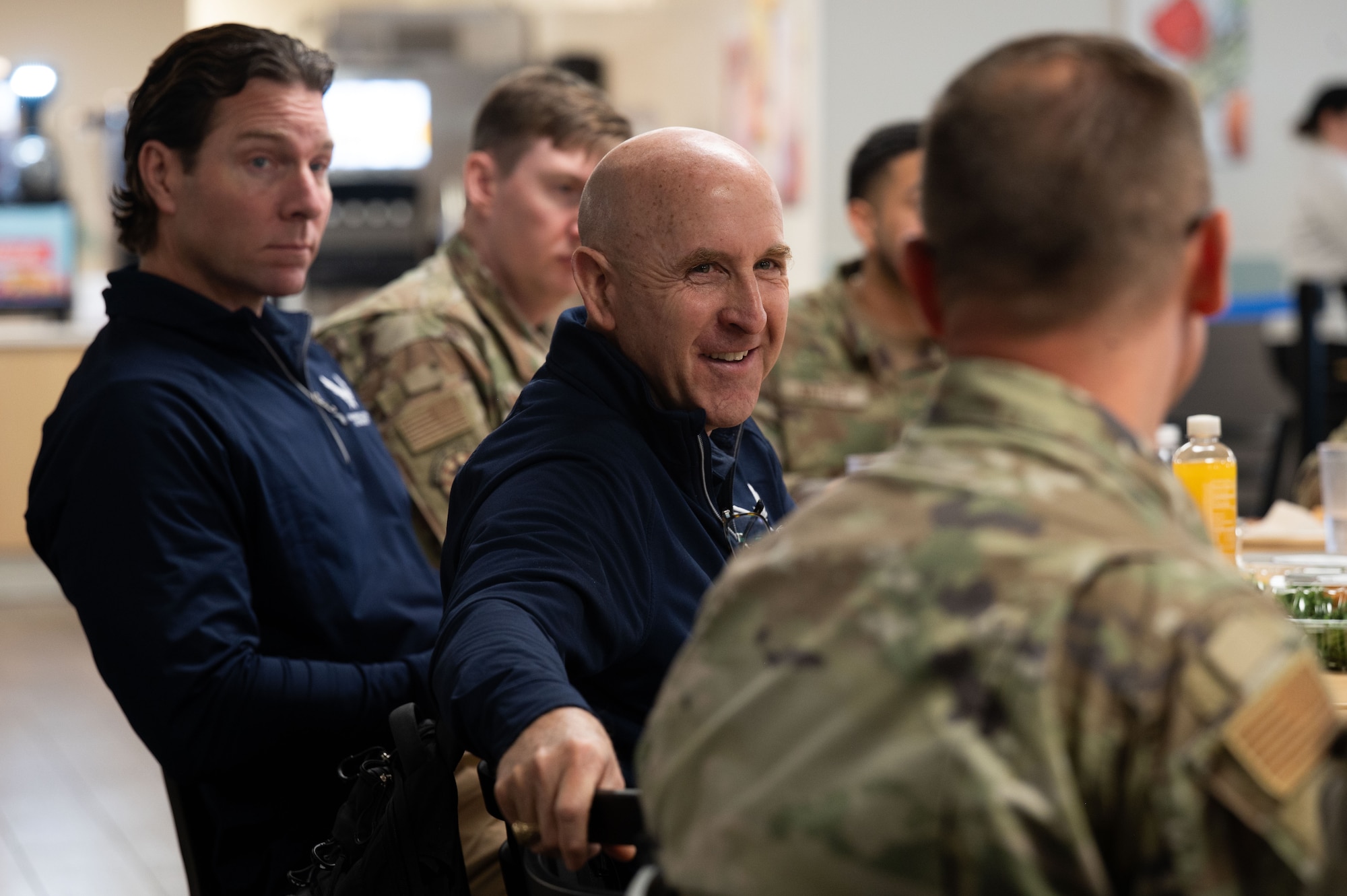Packy Lyden, Air and Space Forces Aid Society chief development officer, left, and U.S. Air Force  Maj. Gen. Ed Thomas,  AFAS chief executive officer, center, speak with an Airman about AFAS programs at Davis-Monthan Air Force Base, Arizona, April 29, 2026. AFAS provides support to Airmen, Guardians and their families through emergency assistance and quality-of-life programs. (U.S. Air Force photo by Airman 1st Class Jaden Kidd)
