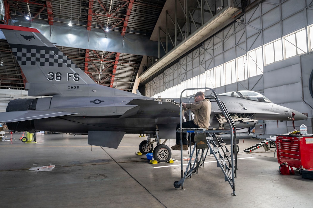 U.S. Air Force Staff Sgt. Logan Cindrich, 36th Fighter Generation Squadron weapons load crew chief, replaces an aircraft harness on an F-16 Fighting Falcon during RED FLAG-Alaska 26-1 at Eielson Air Force Base, Alaska, April 29, 2026. In addition to aircrew, RF-A provides training for deployed maintenance and support personnel in sustainment of large-force deployed air operations. (U.S. Air Force photo by Tech. Sgt. Mikaley Kline)
