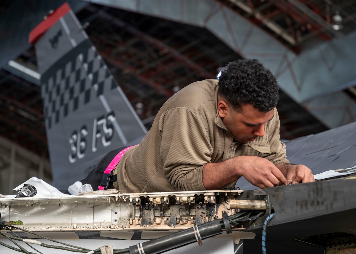 U.S. Air Force Senior Airman Rodirick Witherspoon, 36th Fighter Generation Squadron weapons load crew member, replaces an aircraft harness on an F-16 Fighting Falcon during RED FLAG-Alaska 26-1 at Eielson Air Force Base, Alaska, April 29, 2026. Realistic combat training sustains the readiness required for U.S. air and space operations to prepare for a full range of contingencies. (U.S. Air Force photo by Tech. Sgt. Mikaley Kline)