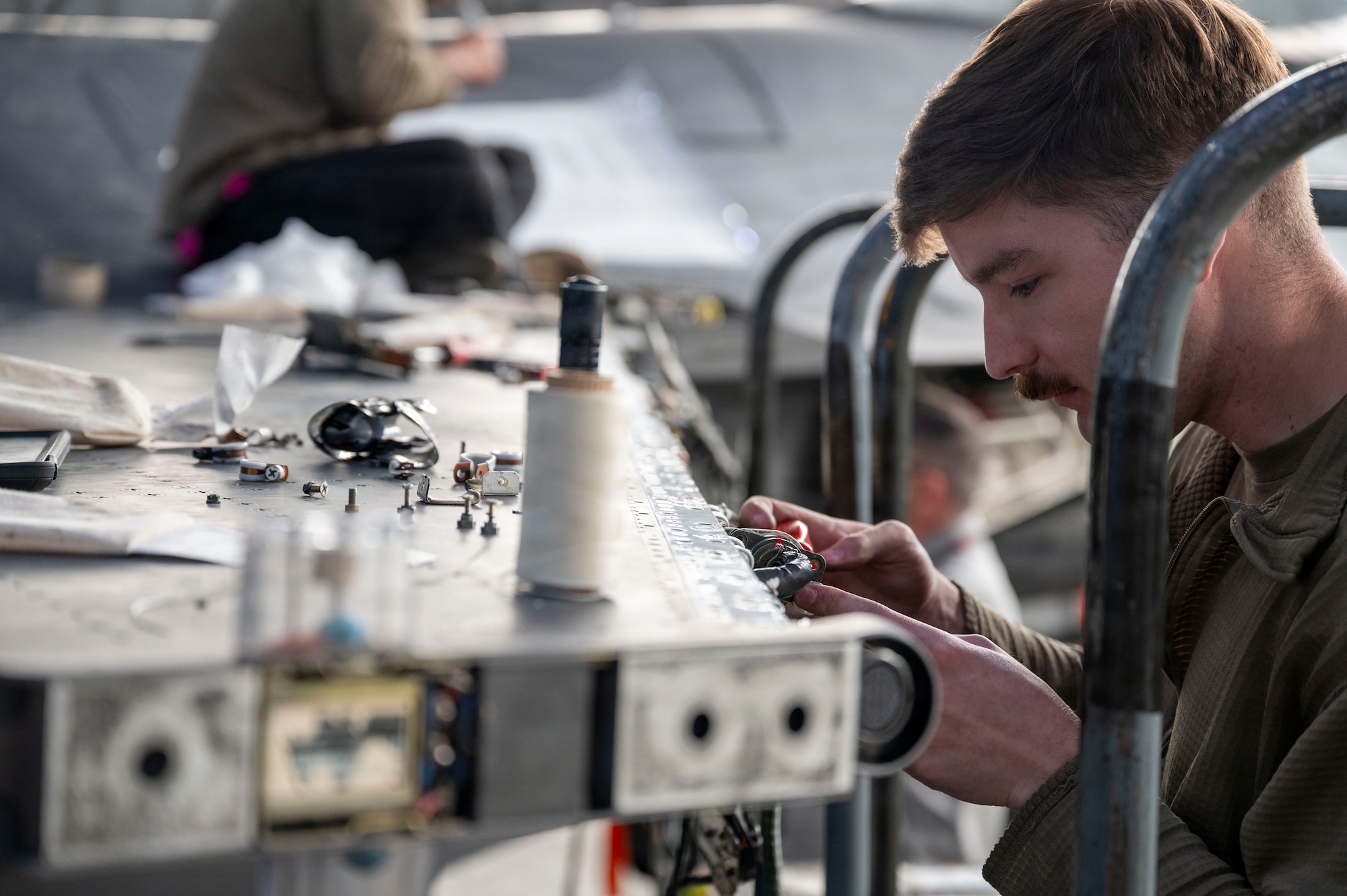 U.S. Air Force Staff Sgt. Logan Cindrich, 36th Fighter Generation Squadron weapons load crew chief, replaces an aircraft harness on an F-16 Fighting Falcon during RED FLAG-Alaska 26-1 at Eielson Air Force Base, Alaska, April 29, 2026. Realistic combat training sustains the readiness required for U.S. air and space operations to prepare for a full range of contingencies. (U.S. Air Force photo by Tech. Sgt. Mikaley Kline)