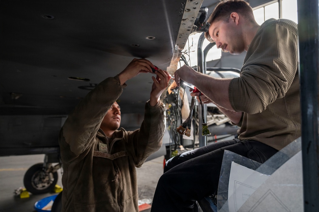 U.S. Air Force Airman 1st Class Brandon Turrubiartes, 36th Fighter Generation Squadron weapons load crew member (left), and Staff Sgt. Logan Cindrich, 36th FGS weapons load crew chief (right), replace an aircraft harness on an F-16 Fighting Falcon during RED FLAG-Alaska 26-1 at Eielson Air Force Base, Alaska, April 29, 2026. Dynamic flying operations during RF-A 26-1 help identify the training, equipment, and capabilities the Joint Force requires to operate in the Arctic and other challenging environments, ensuring homeland defense against a variety of threats. (U.S. Air Force photo by Tech. Sgt. Mikaley Kline)