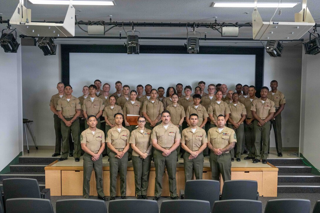 U.S. Marine Corps Corporals Course 3-26 graduates and instructors pose for a photo after their graduation ceremony at Marine Corps Air Station Iwakuni, Japan, April 24, 2026. U.S. Marines from Marine Corps Installations Pacific came to MCAS Iwakuni to receive a month-long professional military education course that teaches non-commissioned officers the fundamentals of leadership. (U.S. Marine Corps photo by Lance Cpl. Tyler Bassett)