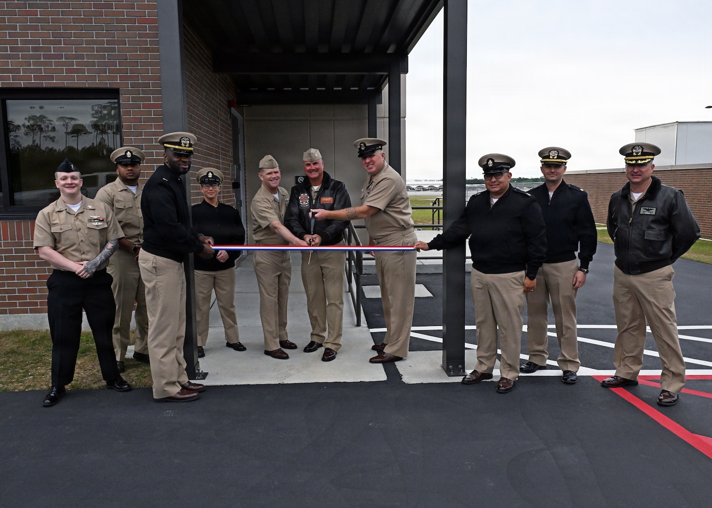 Leadership from across Naval Air Station Whiting Field and Training Air Wing Five gather to cut the ribbon for the installation’s new air traffic control tower April 6, 2026.  The new tower will directly support T-6 Texan II flight operations, increasing air traffic control capabilities. NAS Whiting Field plays a critical role in producing mission-ready aviators who support the national defense of our nation, delivering high-quality flight training while reinforcing its commitment to operational excellence. (U.S. Navy photo by Christy Mason)