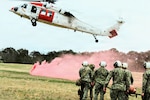 U.S. Navy Hospital Corpsmen assigned to Navy Medicine Readiness and Training Command (NMRTC) Patuxent River transport a simulated casualty on a litter toward an MH-60S Sea Hawk helicopter from the Naval Air Station Patuxent River Search and Rescue (SAR) 