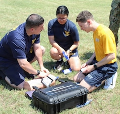 U.S. Navy medical personnel practice wound packing and massive hemorrhage management using a Z-Medica Hemorrhage Control Training Kit during a joint Tactical Combat Casualty Care (TCCC) evolution at Naval Support Facility (NSF) Indian Head, Maryland. The collaborative training brought together Sailors from Navy Medical Readiness and Training Unit (NMRTU) Dahlgren, NMRTC-Detachment Indian Head, and NMRTC-Detachment Joint Base Andrews to target the "M" (Massive Bleeding) phase of the MARCH trauma algorithm. Conducted under the "Warrior Wednesday" initiative, the drill utilized synthetic tissue trainers and hemostatic gauze to build tactical muscle memory and enhance joint medical readiness across regional commands.