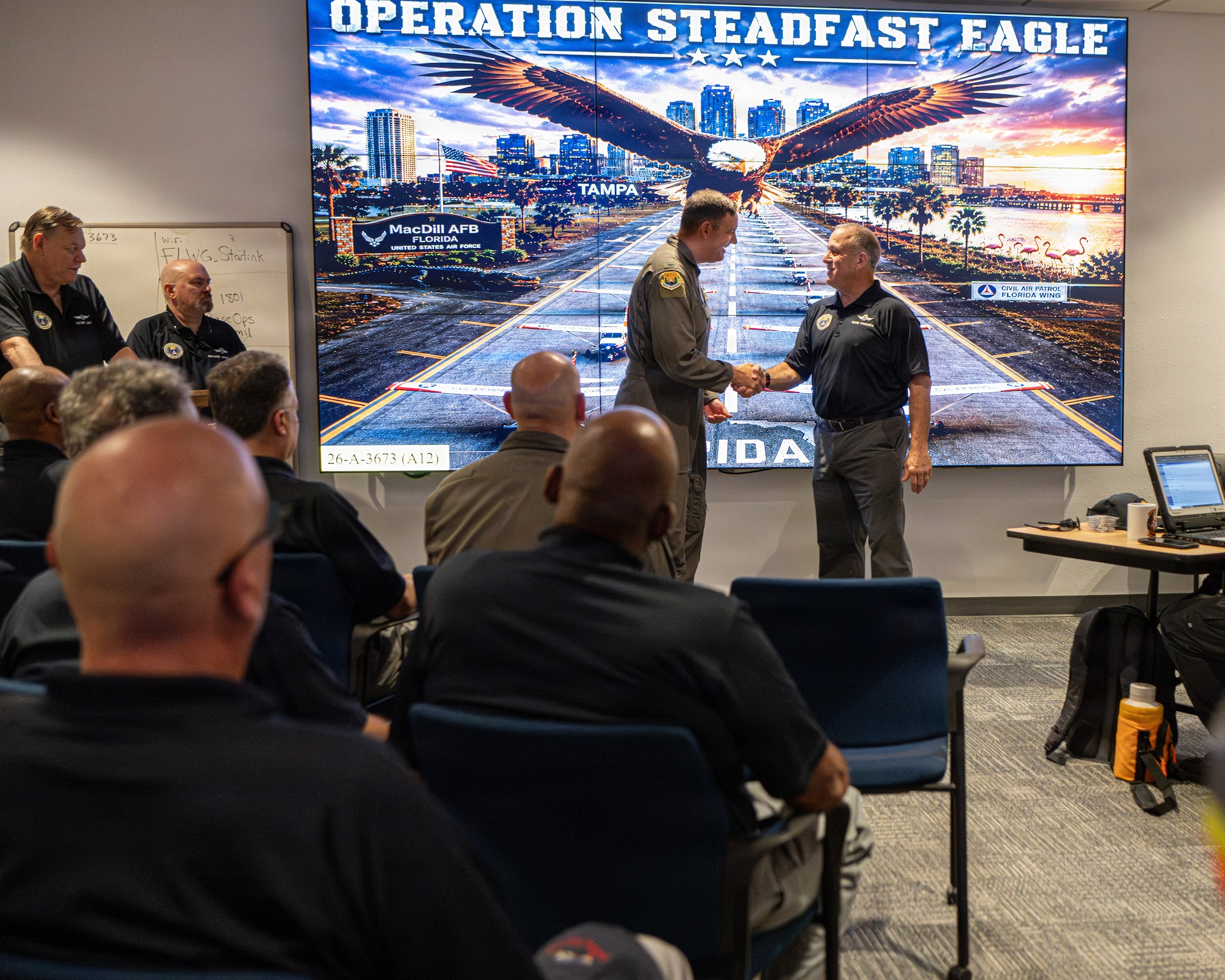 U.S. Air Force Col. Kevin Eley, 6th Air Refueling Wing commander, greets Civil Air Patrol Col. David Panzera, Florida Wing commander, at MacDill Air Force Base, Florida, July 25, 2026. Panzera leads one of the largest wings in the CAP nationwide, with more than 4,000 volunteer members in more than 70 units across Florida. (U.S. Air Force Photo by Airman 1st Class Helen Ly)