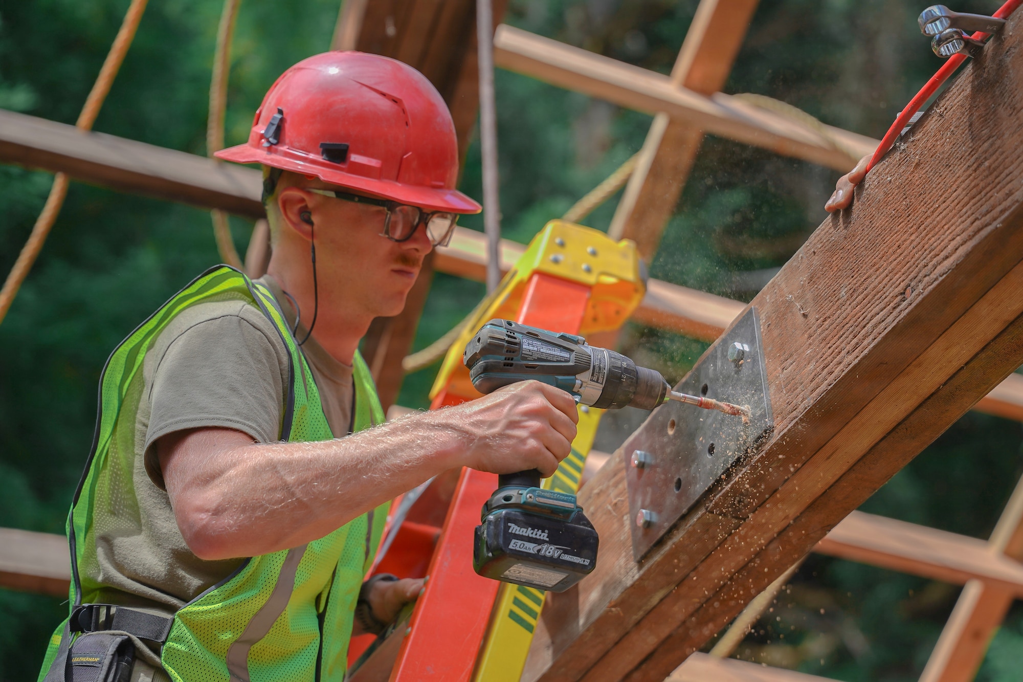 U.S. Air Force Senior Master Sgt. Daniel Hart, the structures senior noncommissioned officer in charge of the 201st Rapid Engineer Deployable Heavy Operational Repair Squadron Engineers, Pennsylvania Air National Guard project, installs reinforcement plates on roof trusses at Redwood National and State Parks near Orick, California, July 14, 2026.