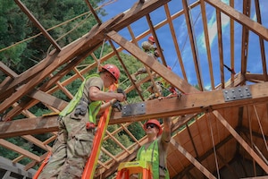 U.S. Air Force Airman, assigned to the 201st Rapid Engineer Deployable Heavy Operational Repair Squadron Engineers, Pennsylvania Air National Guard, install reinforcement plates on roof trusses at Redwood National and State Parks near Orick, California, July 14, 2026.