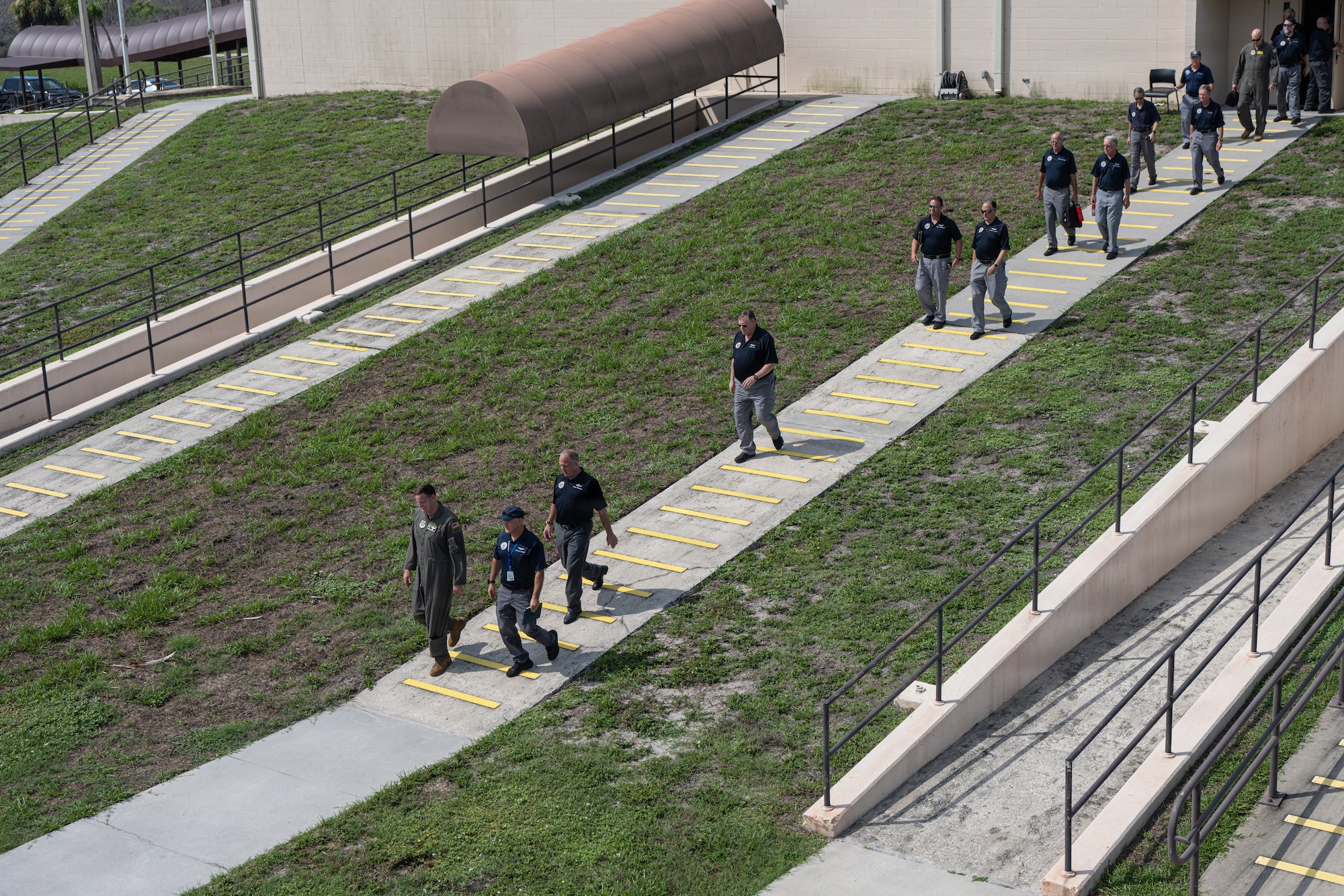 U.S. Air Force Col. Kevin Eley, 6th Air Refueling Wing commander, and Civil Air Patrol Col. David Panzera, Florida Wing commander, lead participants of Operation Steadfast Eagle to the flightline at MacDill Air Force Base, Florida, July 25, 2026. The Florida Wing CAP partnered with the 6th ARW to demonstrate the CAP’s ability to generate and deploy aircraft and crews in support of U.S. Air Force Operations. (U.S. Air Force Photo by Airman 1st Class Helen Ly)