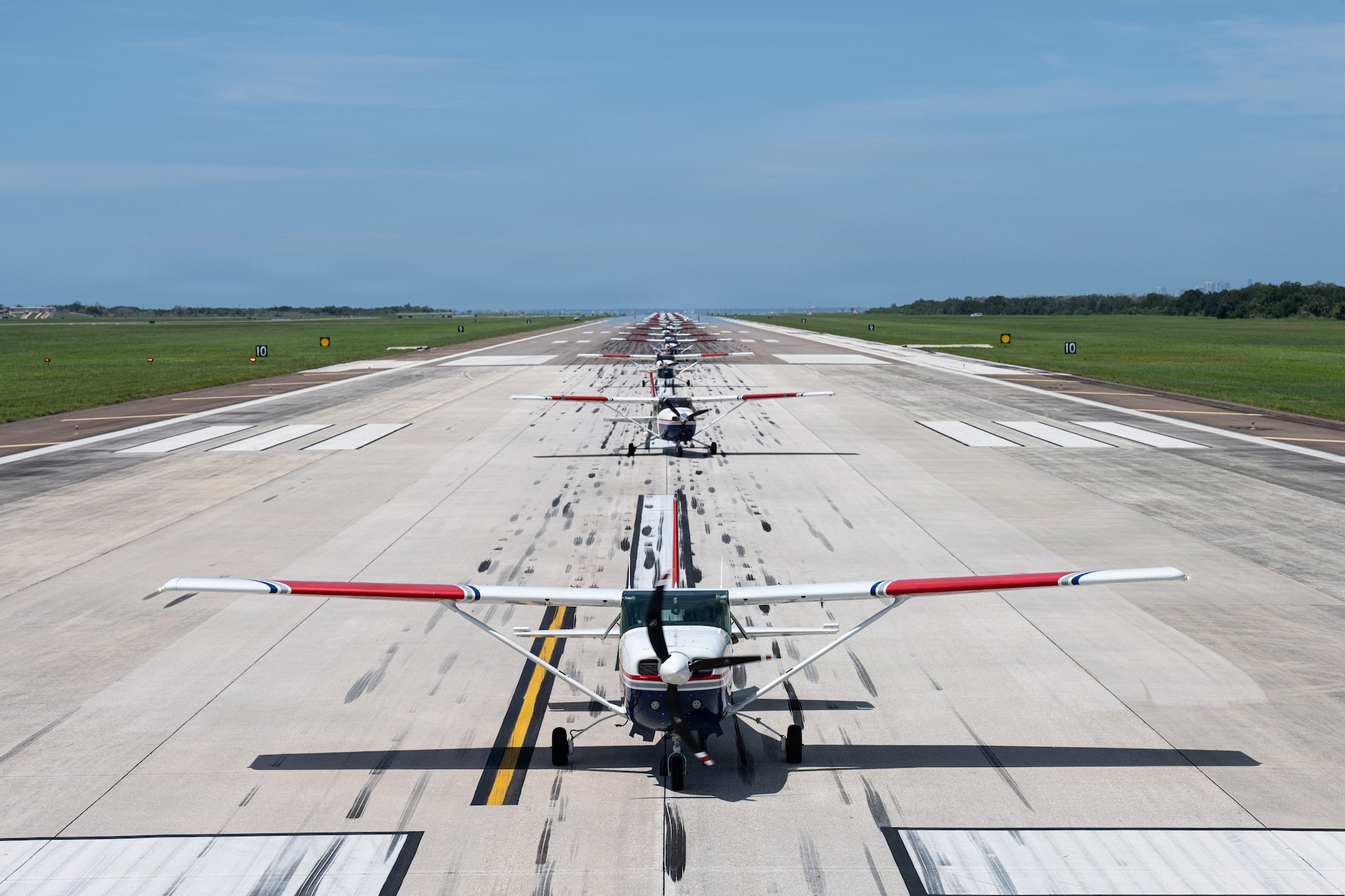 The Florida Wing Civil Air Patrol assembles over 20 Civil Air Patrol Cessna aircraft to perform a synchronized ground movement at MacDill Air Force Base, Florida, July 25, 2026. The Florida Wing CAP assembled over 20 aircraft from across Florida and Tennessee for Operation Steadfast Eagle to demonstrate the CAP’s ability to generate and deploy aircraft and crews in support of U.S. Air Force Operations. (U.S. Air Force Photo by Airman 1st Class Helen Ly)