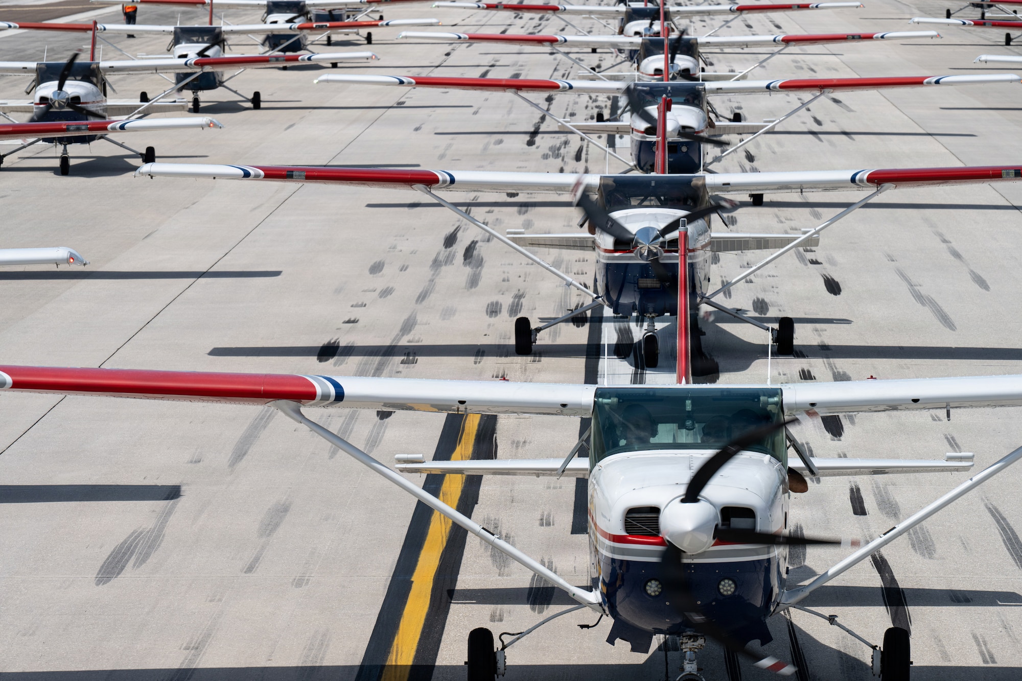 The Florida Wing Civil Air Patrol assembles over 20 CAP Cessna aircraft on the flightline at MacDill Air Force Base, Florida, July 25, 2026. The flightline movement showcased the partnership and combined readiness of the 6th Air Refueling Wing and its U.S. Air Force Auxiliary partners. (U.S. Air Force Photo by Airman 1st Class Helen Ly)
