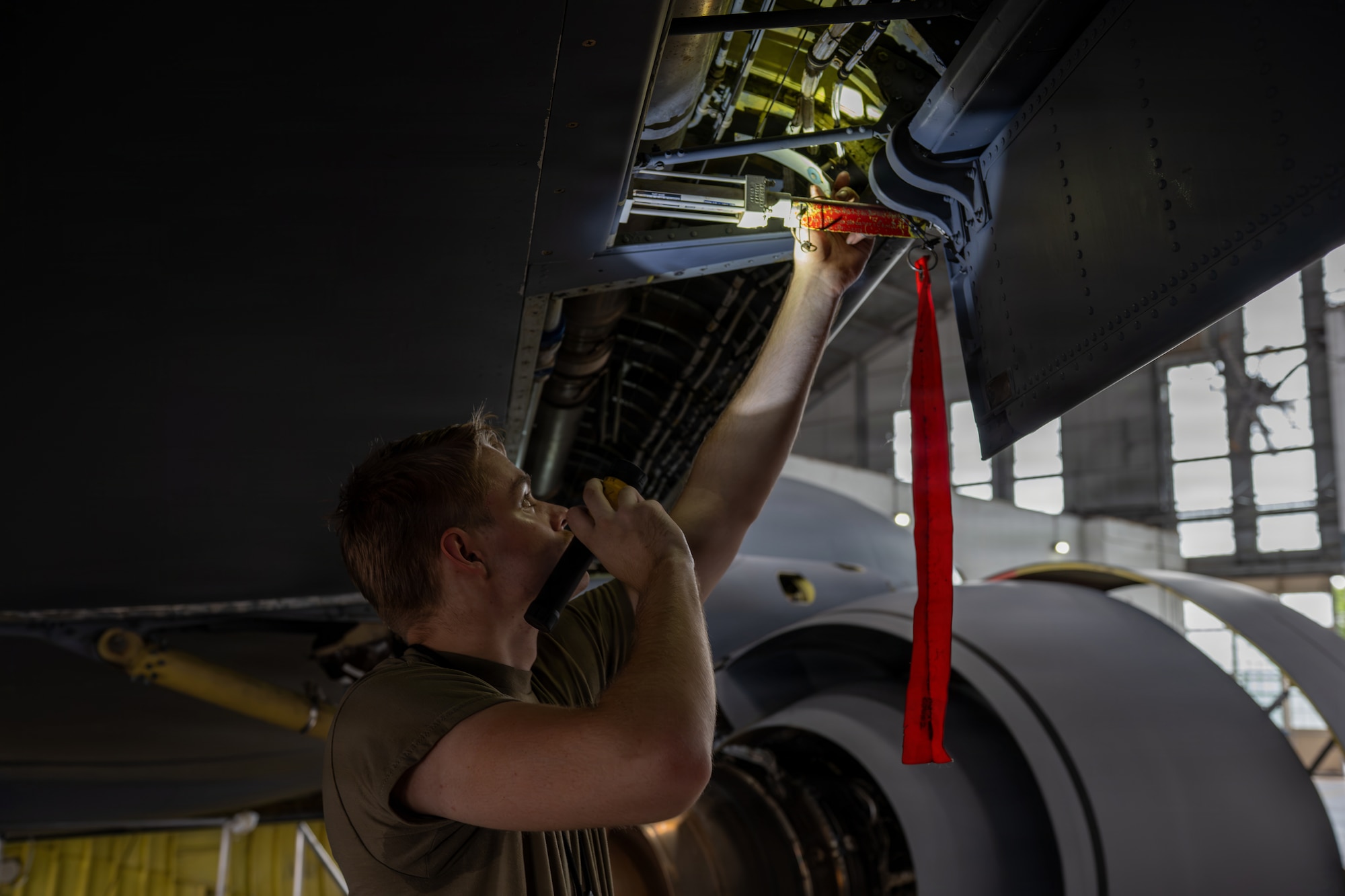 U.S. Air Force Airman 1st Class Nathaniel Wilson, 6th Maintenance Squadron isochronal (ISO) inspection journeyman, uses a flashlight to inspect the integrity of a KC-135 Stratotanker at MacDill Air Force Base, Florida, July 29, 2026. KC-135s receive an ISO inspection every 1,800 flying hours to ensure safety and efficiency. (U.S. Air Force photo by Senior Airman Derrick Bole)