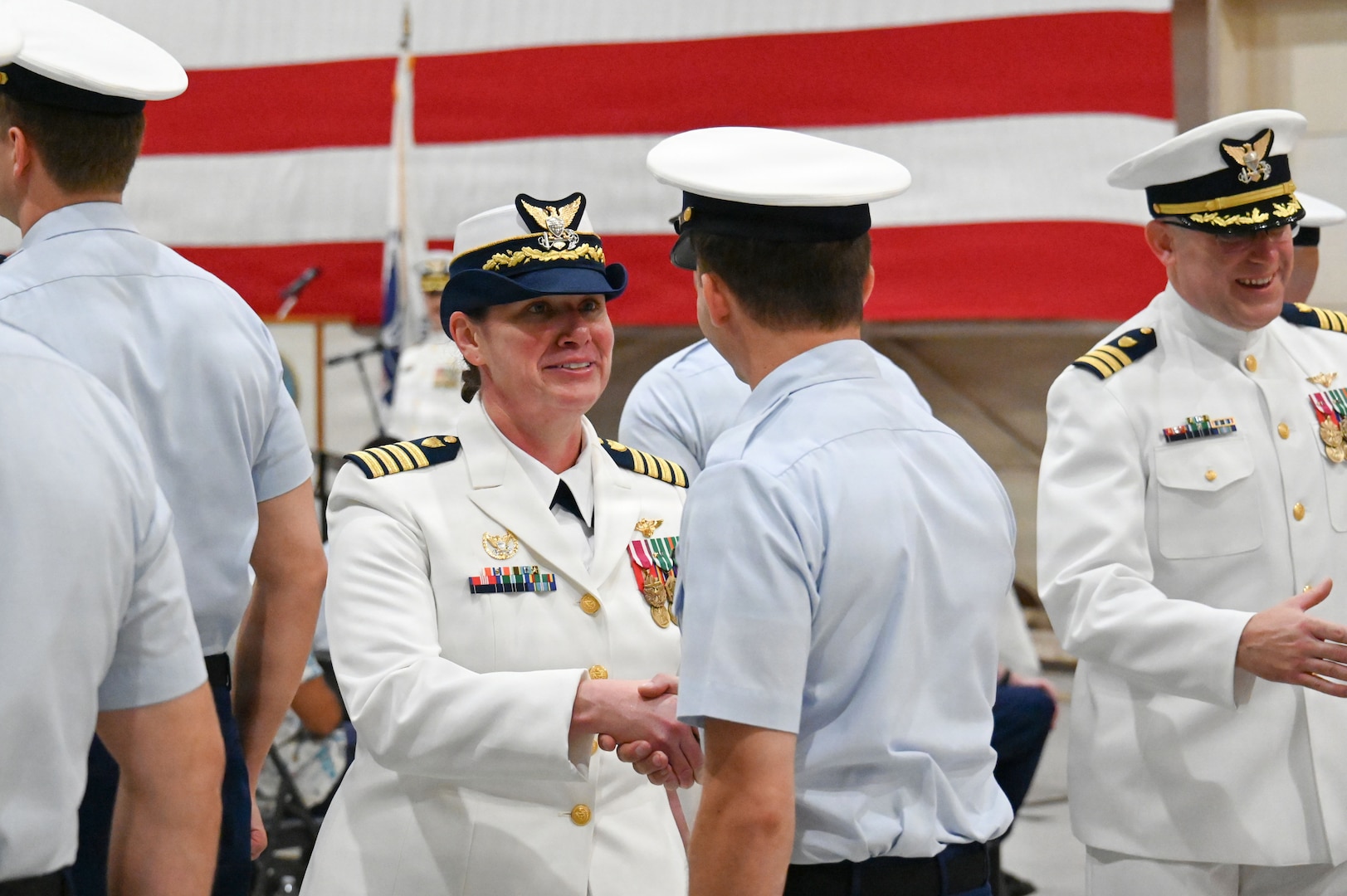 Coast Guard Capt. Maegan Schwartz shakes hands with an Air Station Savannah crew member during a personnel inspection as part of the change-of-command ceremony in Savannah, Georgia, July 31, 2026. During the ceremony, Schwartz transferred command of Air Station Savannah to Cmdr. Zachary Wiest. (U.S. Coast Guard photo by Petty Officer 1st Class Brandon Hillard)