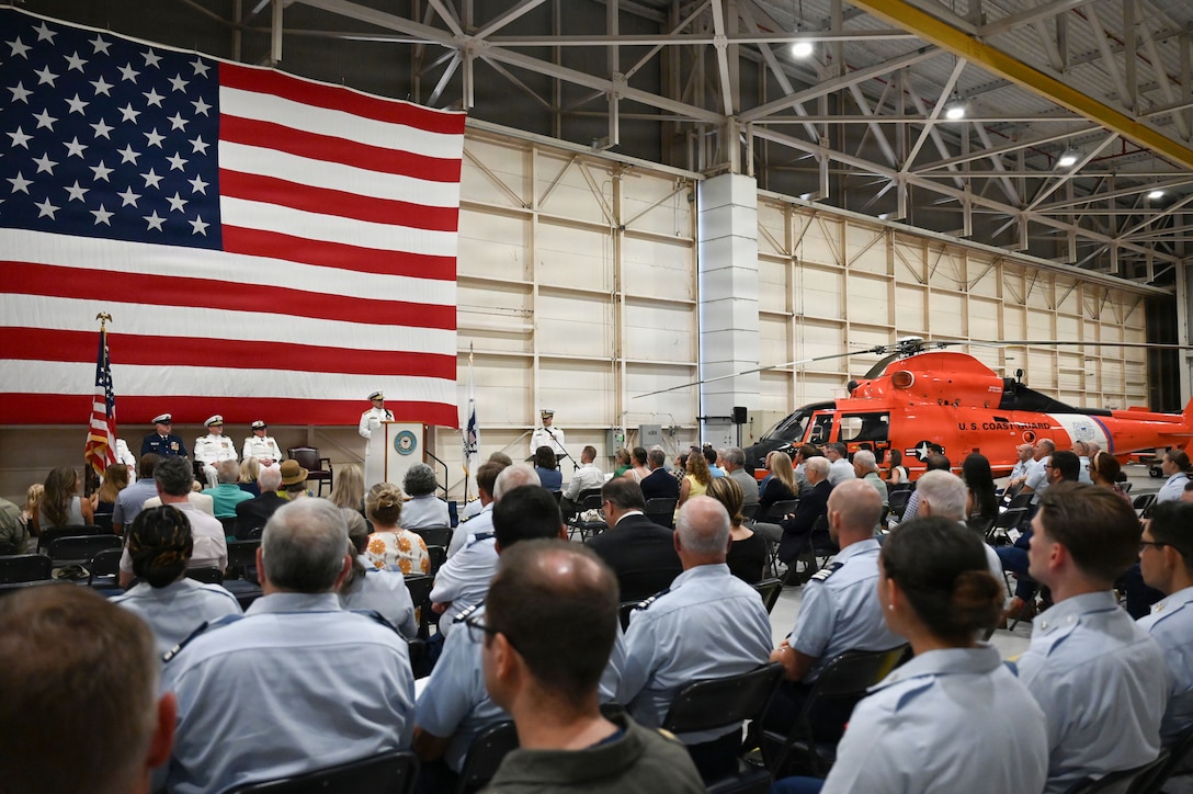 Coast Guard Rear Adm. Adam Chamie, commander, Southeast Coast Guard District, delivers remarks during a change-of-command ceremony held at Air Station Savannah, Georgia, July 31, 2026. During the ceremony, Capt. Maegan Schwartz transferred command of Air Station Savannah to Cmdr. Zachary Wiest. (U.S. Coast Guard photo by Petty Officer 1st Class Brandon Hillard)