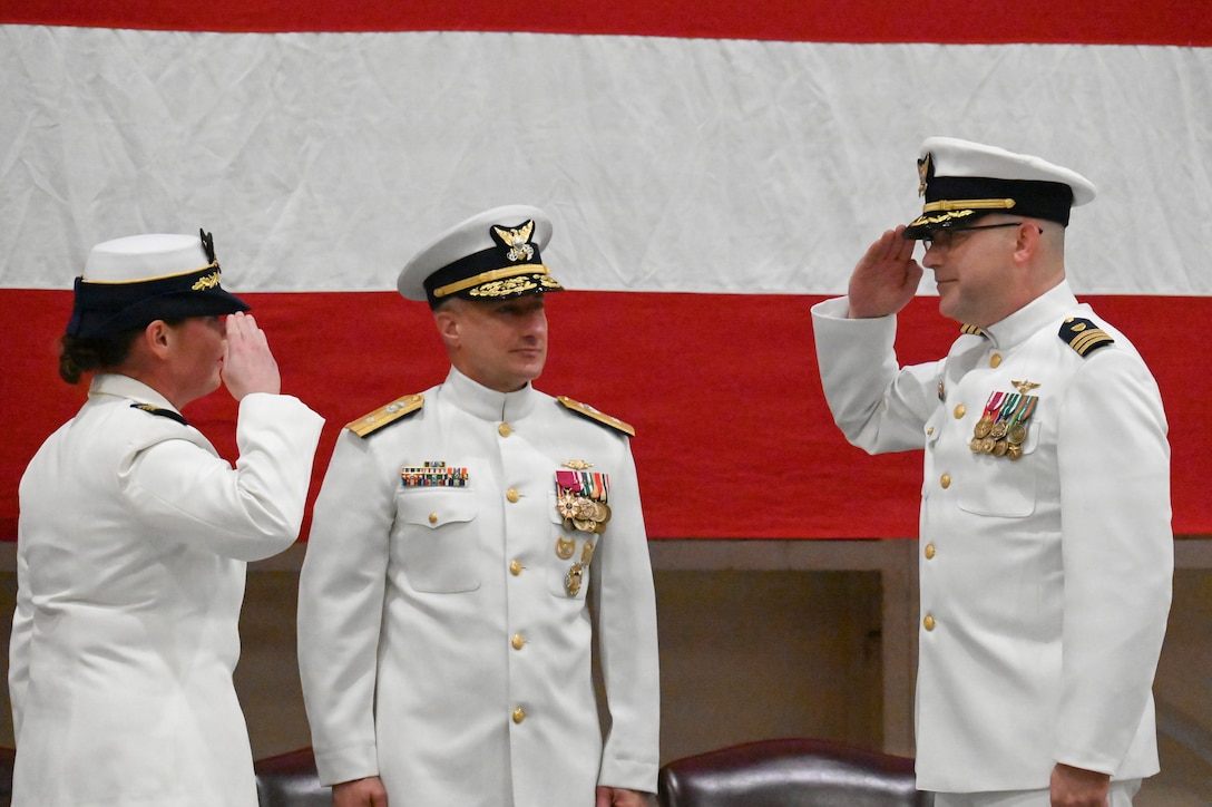 U.S. Coast Guard Cmdr. Zachary Wiest, right, salutes, Capt. Maegan Schwartz during a change-of-command ceremony presided over by Rear Adm. Adam Chamie, center, in Savannah, Georgia, July 31, 2026. The change-of-command ceremony marks a transfer of total responsibility and authority from one individual to another. (U.S. Coast Guard photo by Petty Officer 1st Class Brandon Hillard)