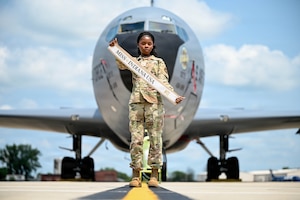 SrA Oke poses in front of an aircraft