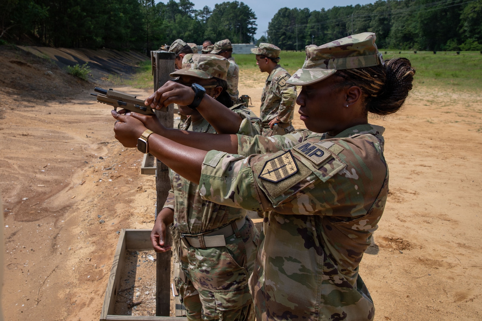 (From left) U.S. Army Spc. Wytega Williams and Pfc. Quiana Tiggle, military police with the 273rd Military Police Company, 372nd Enhanced Military Battalion, 260th Special Purpose Brigade, practice proper weapons handling on the range at Fort A.P. Hill, Virginia, July 29, 2026. This training was part of a multi-day advanced marksmanship exercise focused on enhancing individual and team weapons proficiency while preparing soldiers for contingency operations.