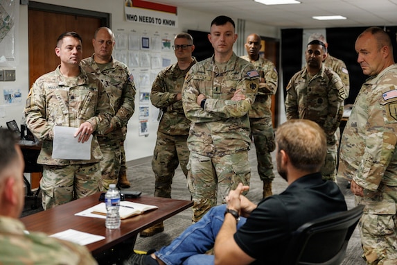 Alex Miller, the U.S. Army's Chief Technology Officer, talks with U.S. National Guardsmen assigned to Joint Task Force-District of Columbia, in support of the DC Safe and Beautiful mission, at the DC Armory in Washington, July 26, 2026. About 5,000 National Guard members are supporting the mission, providing critical assistance to the Metropolitan Police Department to help ensure the safety of residents, commuters, and visitors throughout the District.