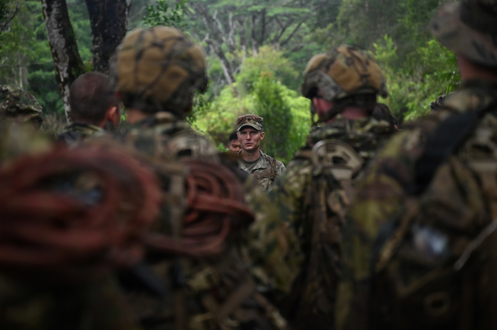 Maj. Eric Minshaw, commander of the 178th Security Forces Squadron, speaks to Security Forces Airmen following annual training at Schofield Barracks, Hawaii, July 23, 2026. The training challenged Airmen to strengthen tactical proficiency, teamwork and expeditionary readiness while operating in unfamiliar terrain and austere conditions. (U.S. Air National Guard photo by Tech. Sgt. Tiffany Scofield)