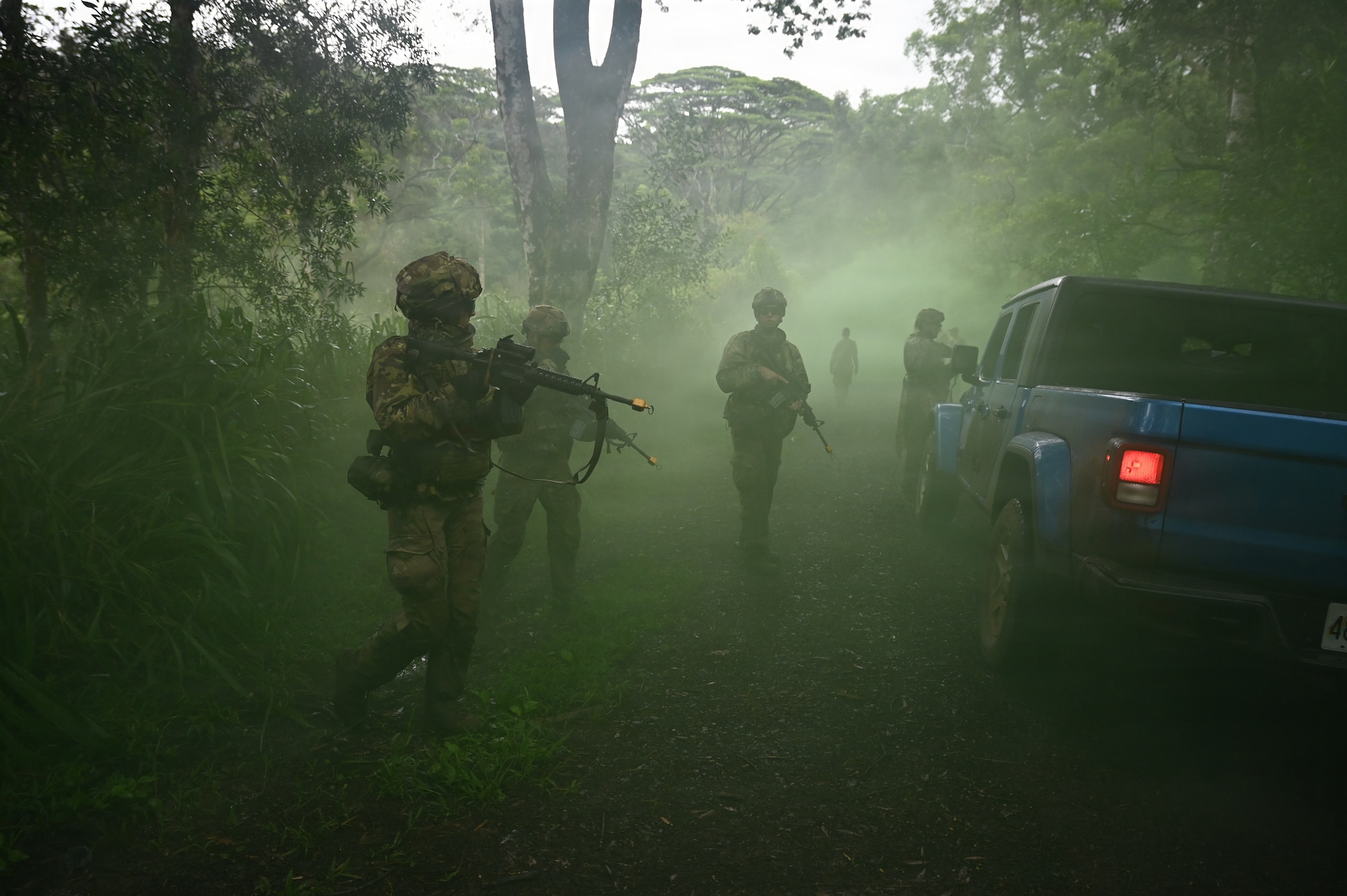 Security Forces Airmen assigned to the Ohio Air National Guard's 178th Security Forces Squadron conduct an ambush exercise using smoke grenades during annual training at Schofield Barracks, Hawaii, July 23, 2026. The training challenges Airmen to strengthen tactical proficiency, teamwork and expeditionary readiness while operating in unfamiliar terrain and austere conditions. (U.S. Air National Guard photo by Tech. Sgt. Tiffany Scofield)