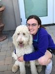 Katherine Bain poses for a photo with her family dog, Linus, a poodle mix. Bain recently left the Nevada Air National Guard to pursue veterinary school at Cornell University. Without her military service, Bain said she would not have been admitted to the Ivy League university.