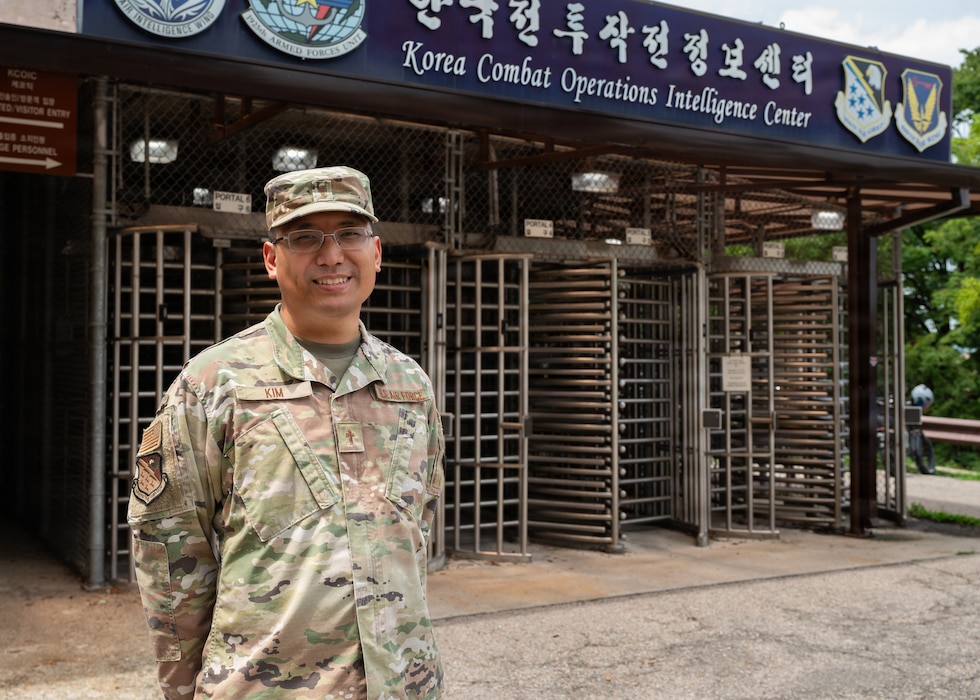 Man poses in front of building