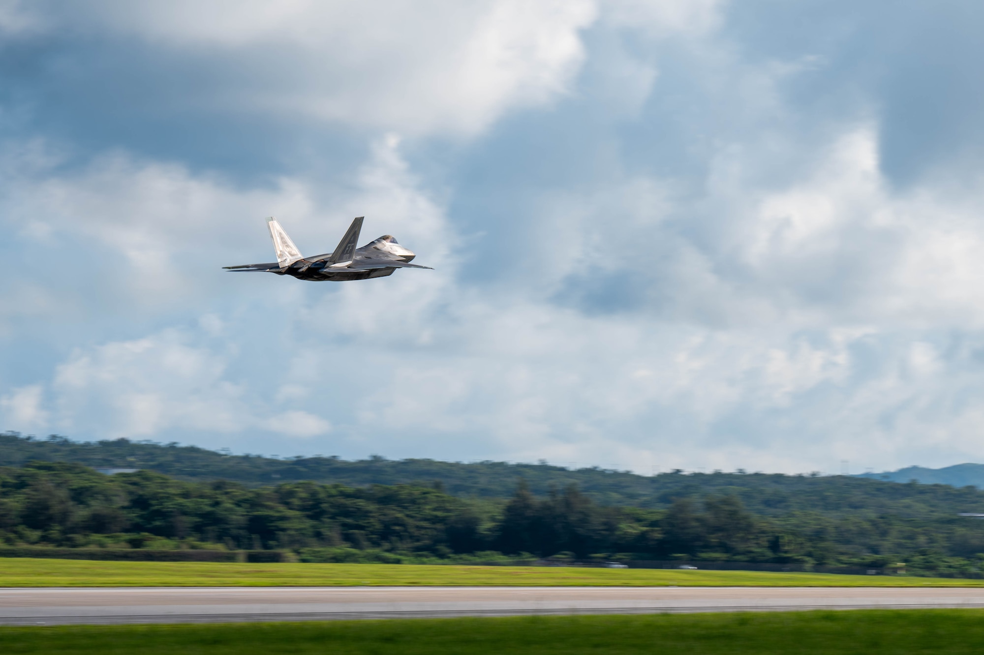 A U.S. Air Force F-22 Raptor assigned to the 27th Expeditionary Fighter Squadron, deployed to Kadena Air Base, takes off during readiness exercise BB26-1 at Kadena Air Base, Japan, Aug. 3, 2026. Kadena Air Base's strategic position makes it a vital staging location for forces to deter regional adversaries and project U.S. airpower throughout the Indo-Pacific. (U.S. Air Force photo by Airman 1st Class Nathaniel Jackson)