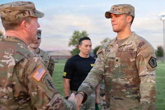 Army Brig. Gen. Colin Morrow, Deputy Commanding General, 84th Training Command, presents Spc. Devin Lyons, Tactical Power Generation Specialist, Kentucky National Guard, a challenge coin, July 31, 2026 at Fort Knox Ky.  Lyons, had an overall best time of 17:00 min and was not required to take the CFT but chose to challenge himself.( Army Reserve photo by Staff Sgt. David Campo-Contreras)