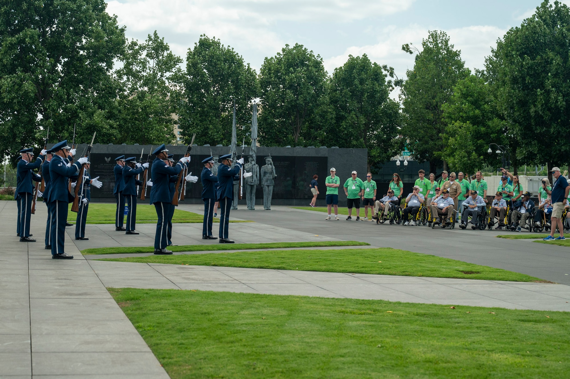 Ceremonial guardsmen with the U.S. Air Force Honor Guard Drill Team perform at the Air Force Memorial in front of veterans
