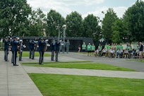 Ceremonial guardsmen with the U.S. Air Force Honor Guard Drill Team perform at the Air Force Memorial in front of veterans