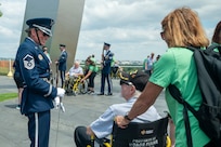U.S. Air Force Honor Guard Drill Team flight chief, speaks with a veteran  in front of the Air Force memorial