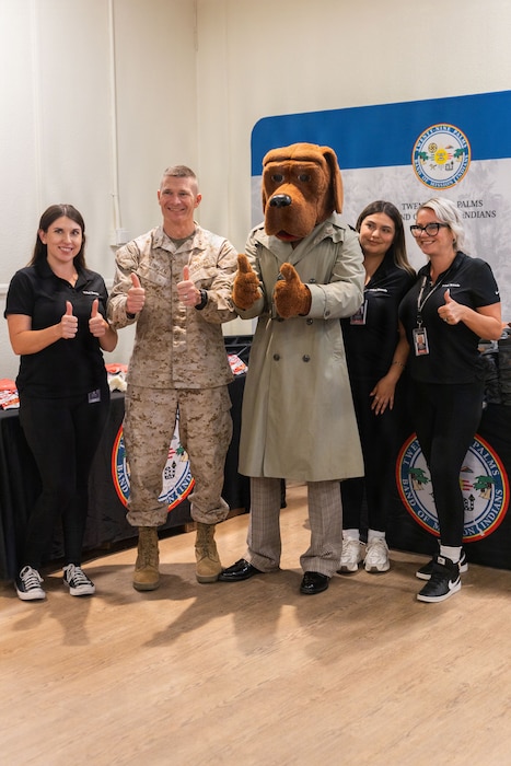 U.S. Marine Corps Maj. Gen. Mark H. Clingan, the commanding general of Marine Air Ground Task Force Training Command, Marine Corps Air Ground Combat Center, poses with event staff during the Back-to-School Resource Fair at Mojave Landing, MCAGCC, Twentynine Palms, California, July 23, 2026. The Back-to School Resource Fair allows families and students to meet important and integral parts of the community, while receiving free school supplies. (U.S. Marine Corps photo by Lance Cpl. Eliza Francka)