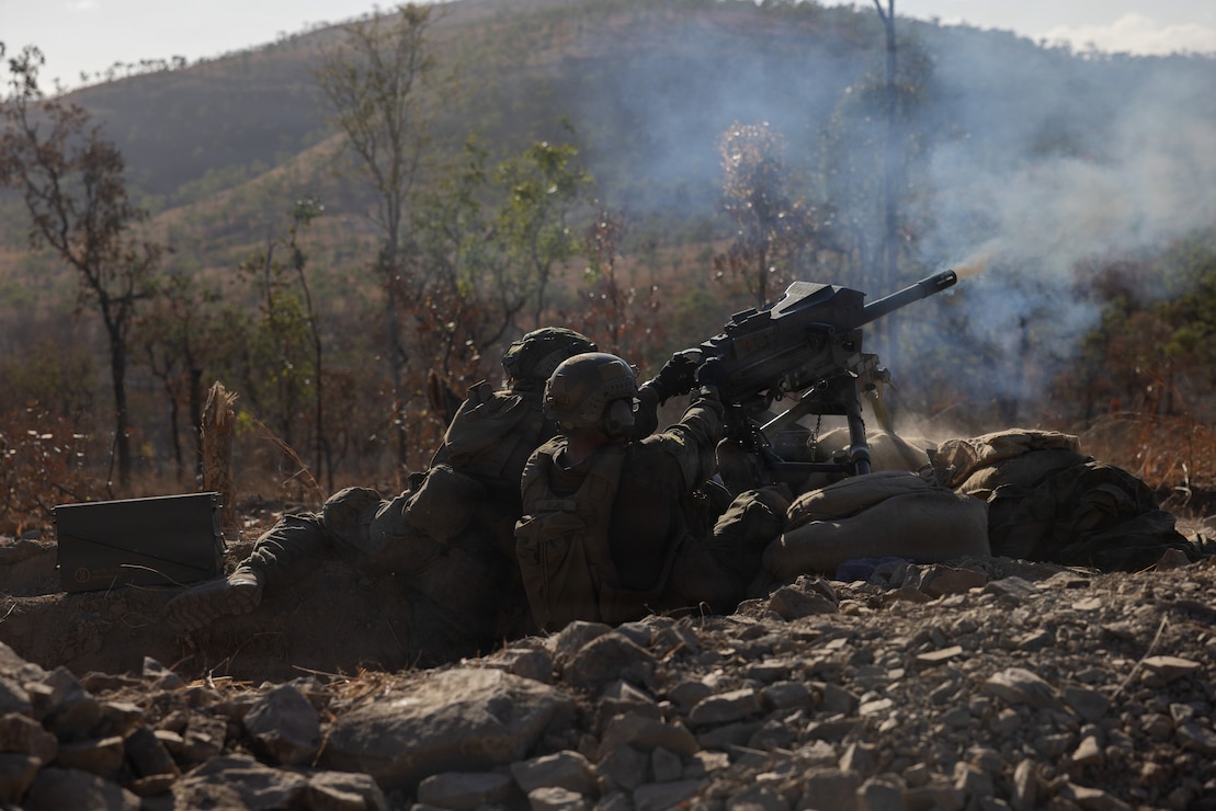 U.S. Marine Corps Lance Cpl. Landon Nelson, left, and Lance Cpl. Rosalas Rojas, both machine gunners with 1st Battalion, 5th Marine Regiment, Marine Rotational Force – Darwin 26, fire an MK-19 40 mm automatic grenade launcher as part of a multinational live-fire drill during Exercise Predator’s Run 26 at Townsville Field Training Area in Queensland, Australia, July 27, 2026.