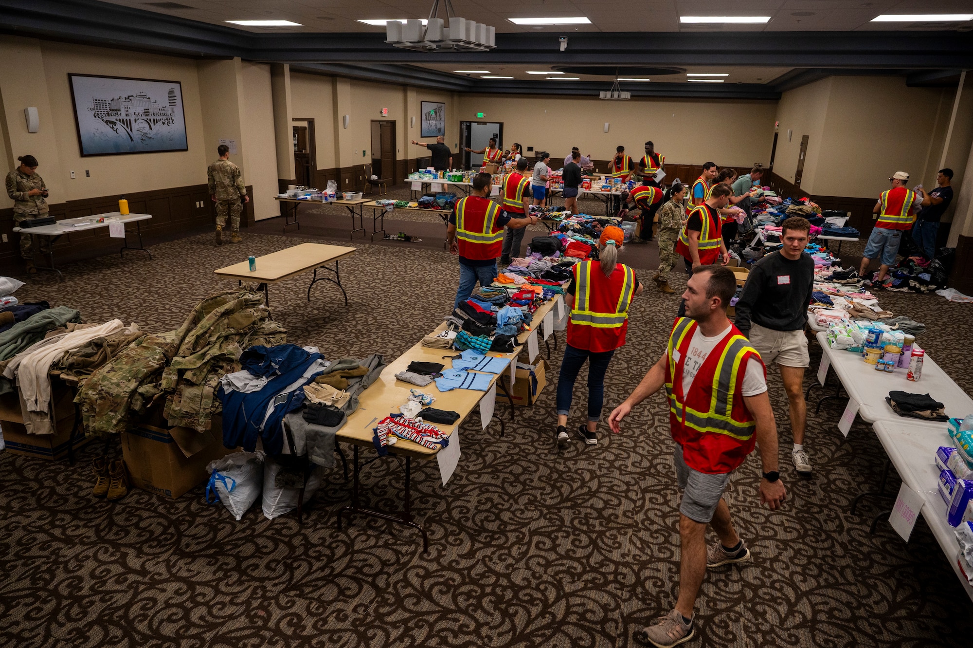 Volunteers for an Emergency Family Assistance Center process donations on Fairchild Air Force Base, Washington.