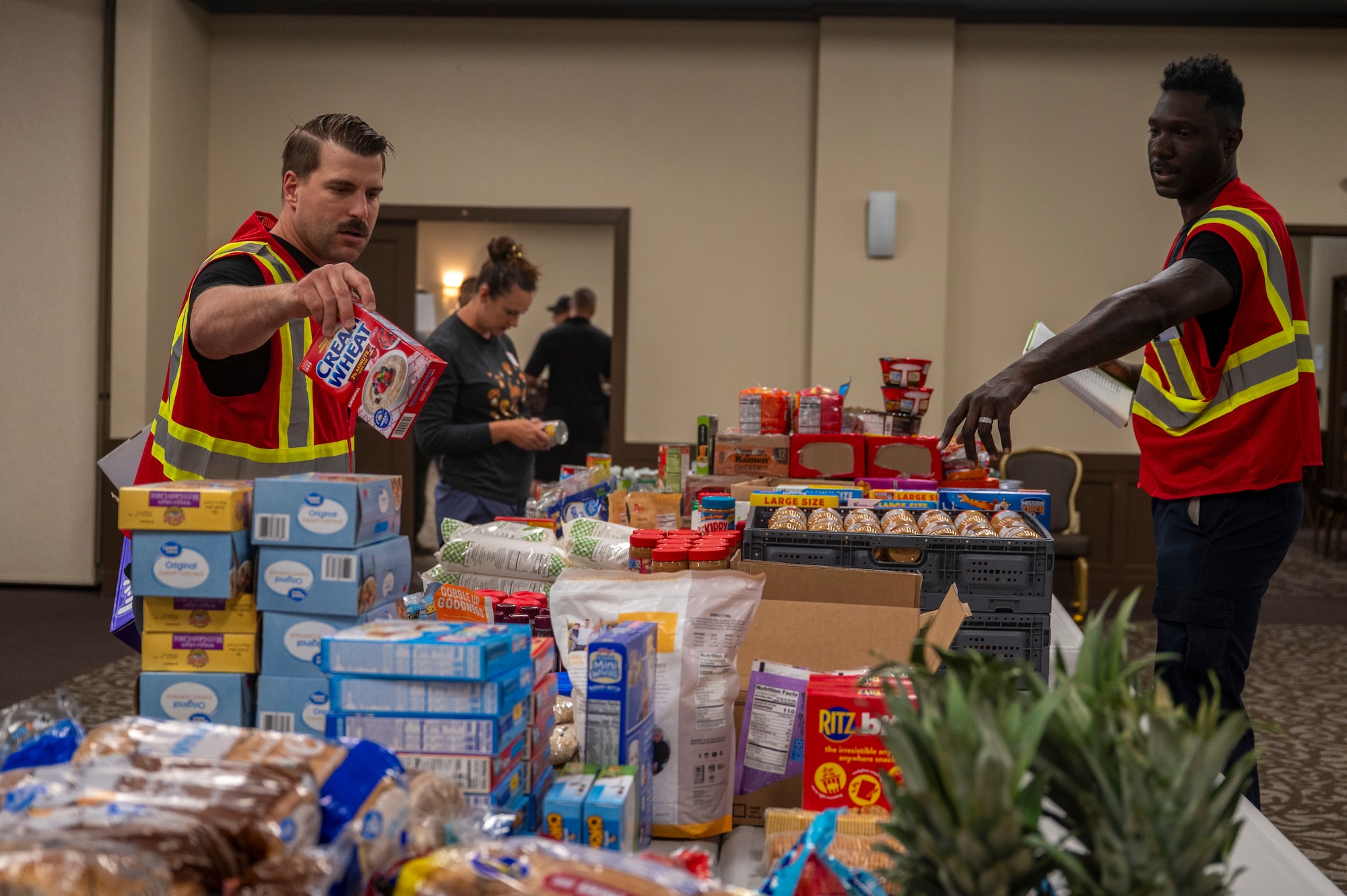 Volunteers for an Emergency Family Assistance Center process donations on Fairchild Air Force Base, Washington.