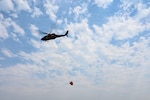 A UH-60 Black Hawk assigned to the 1st Battalion, 168th General Support Aviation Battalion, takes off to support a water drop mission on the Modrite Fire in Ferry County, Washington. Since 2012, more than 4,500 Guard members have partnered directly with the Washington State Department of Natural Resources, delivering steadfast relief to Washington residents and dropping more than 4 million gallons of water on state wildfires. Photo by Master Sgt. Brandy Burke.
