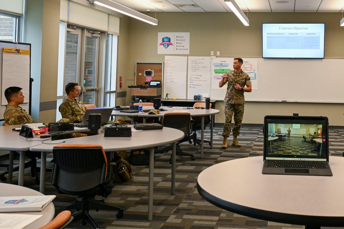 U.S. Marine Capt. Andrew Suarez, officer-in-charge of the Marine Corps Center for Learning and Faculty Development, Detachment West, Camp Pendleton, California,  talks with other students from the Air National Guard Instructor Course, McGhee Tyson Air National Guard Base, Tennessee, July 22, 2026.  A shared commitment to advancing instructor development brought the first U.S. Marine Corps participant to the I.G. Brown Training and Education Center’s TEC-University Air National Guard Instructor Course. (U.S. Air National Guard photo by Master Sgt. Regina Young)