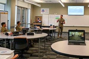 U.S. Marine Capt. Andrew Suarez, officer-in-charge of the Marine Corps Center for Learning and Faculty Development, Detachment West, Camp Pendleton, California,  talks with other students from the Air National Guard Instructor Course, McGhee Tyson Air National Guard Base, Tennessee, July 22, 2026.  A shared commitment to advancing instructor development brought the first U.S. Marine Corps participant to the I.G. Brown Training and Education Center’s TEC-University Air National Guard Instructor Course. (U.S. Air National Guard photo by Master Sgt. Regina Young)