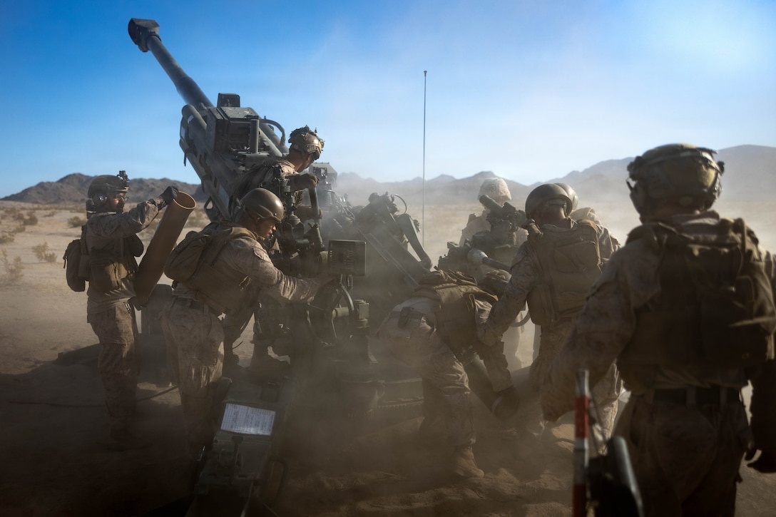 U.S. Marines with 1st Battalion, 11th Marines Regiment, 1st Marine Division, conduct an artillery fire mission during a battery movement to contact exercise as part of Service Level Training Exercise 4-26 at Marine Corps Air Ground Combat Center, Twentynine Palms, California, July 25, 2026. SLTE is a premier training event that ensures the Marine Corps remains a highly lethal, adaptable force capable of dominating the future multi-domain fight. (U.S. Marine Corps photo by Lance Cpl. Emilio Murphy)