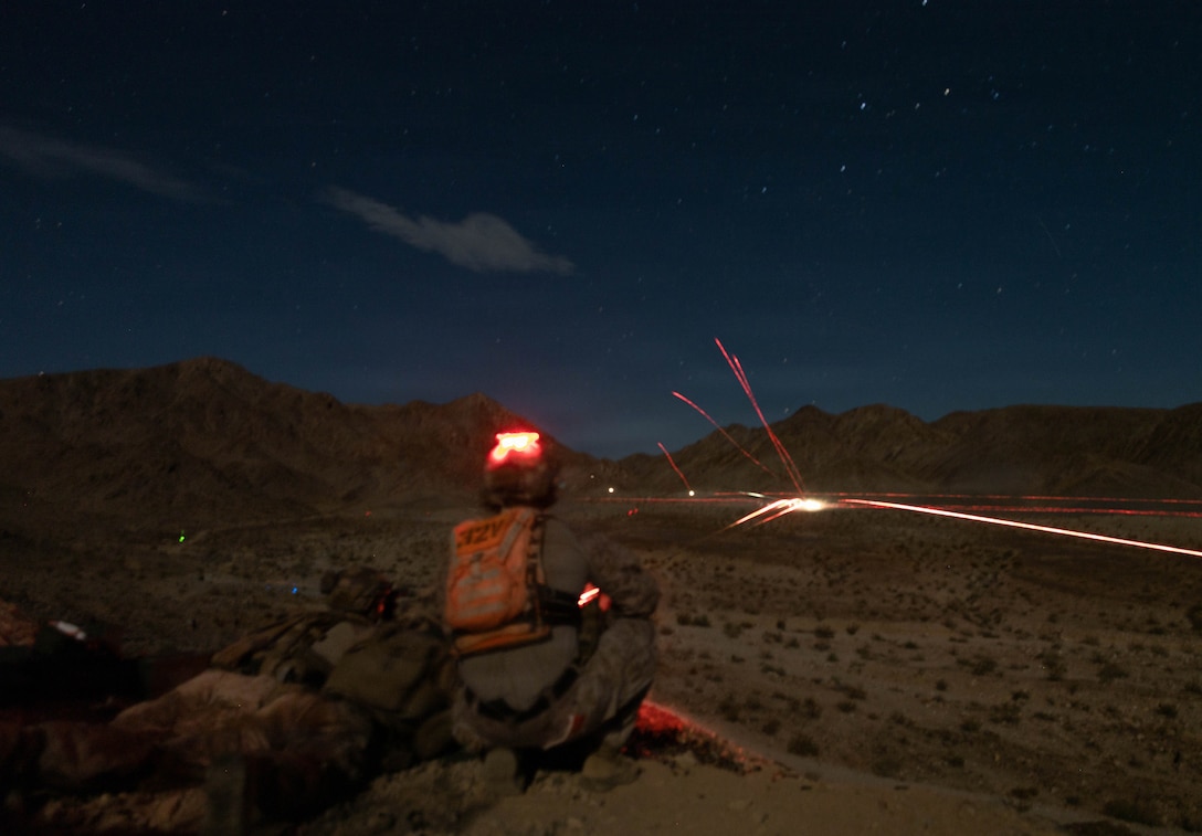 U.S. Marine Corps Sgt. Sean Rafferty, a Massachusetts native and an instructor with Tactical Training and Exercise Control Group, Marine Corps Air Ground Combat Center, observes a night live-fire company attack as part of Service Level Training Exercise 4-26 at Range 400, MCAGCC, Twentynine Palms, California, July 24, 2026. SLTE is a premier training event that ensures the Marine Corps remains a highly lethal, adaptable force capable of dominating the future multi-domain fight. (U.S. Marine Corps photo by Lance Cpl. Grant Gatlin)
