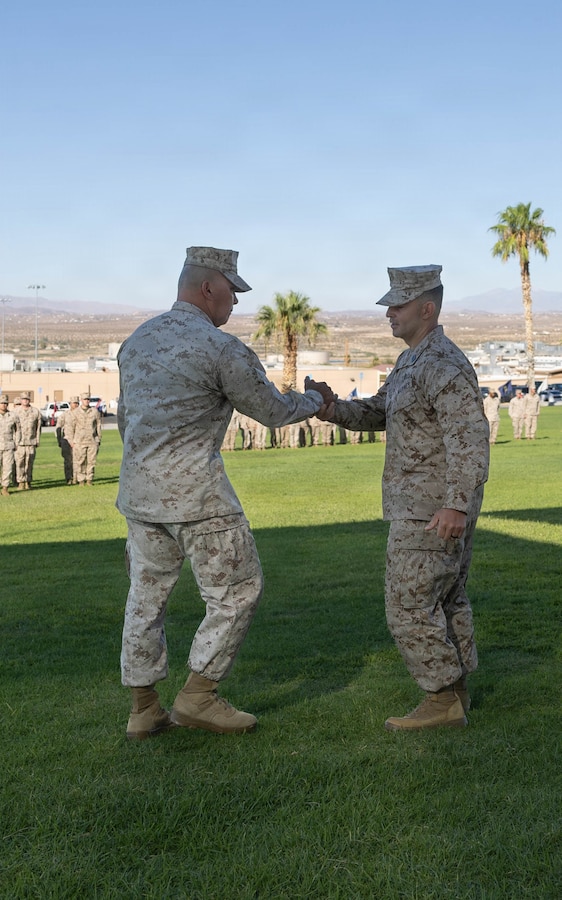 U.S. Marine Corps Sgt. Maj. Robert L. Jacobs, left, outgoing sergeant major of 7th Marine Regiment, 1st Marine Division, shakes hands with Sgt. Maj. Efrain Barrientos, in-coming sergeant major, while conducting a Relief and Appointment Ceremony at Marine Corps Air Ground Combat Center, Twentynine Palms, California, July 29, 2026. The Relief and Appointment signifies the passing of authority from the outgoing sergeant major to the incoming sergeant major. (U.S. Marine Corps photo by Lance Cpl. Grant Gatlin)