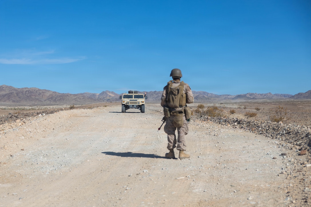 U.S. Marine Corps Pfc. Abraham Silverio, a Georgia native and an automotive maintenance technician with 2nd Maintenance Battalion, 2nd Combat Readiness Regiment, 2nd Marine Logistics Group, halts a Humvee during Land Combat Element Forward Security training as part of Service Level Training Exercise 4-26 at Training Area East, Marine Corps Air Ground Combat Center, Twentynine Palms, California, July 27, 2026. SLTE is a premier training event that ensures the Marine Corps remains a highly lethal, adaptable force capable of dominating the future multi-domain fight. (U.S. Marine Corps photo by Lance Cpl. Lainey Brummett)