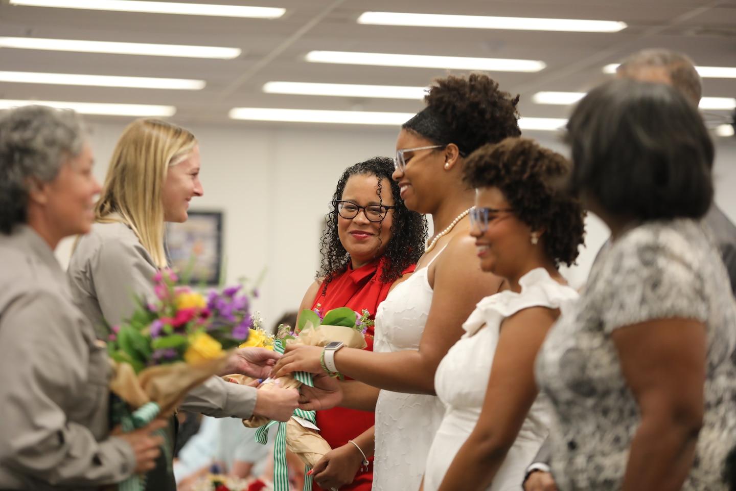 Yellow roses are presented to colonel Ringo’s wife, Mrs. Channa Ringo, followed by flowers for his daughters Skylar and Zoe, and his mother-in-law, Jacqueline, by park rangers Kathryn Champagne and Jennifer Lawson.