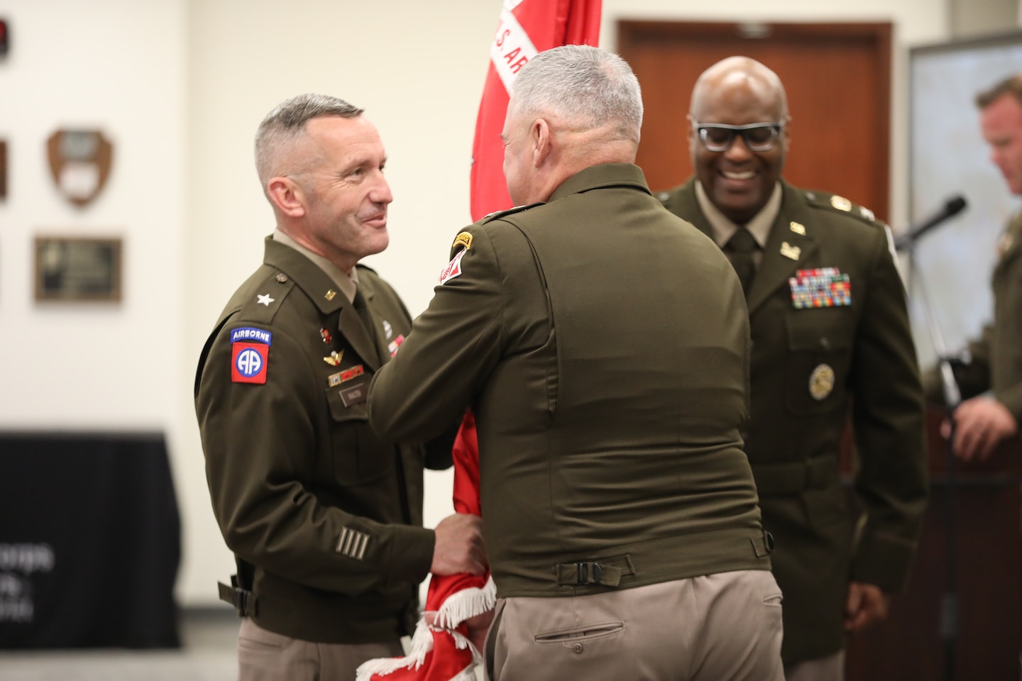 The outgoing commanding officer of the Fort Worth District, Col. Calvin Kroeger, passes the colors to Brig. Gen. George Walter, the Commander of the Southwestern Division, reflecting his gratitude for the opportunity to lead and thereby relinquishing his command responsibility.