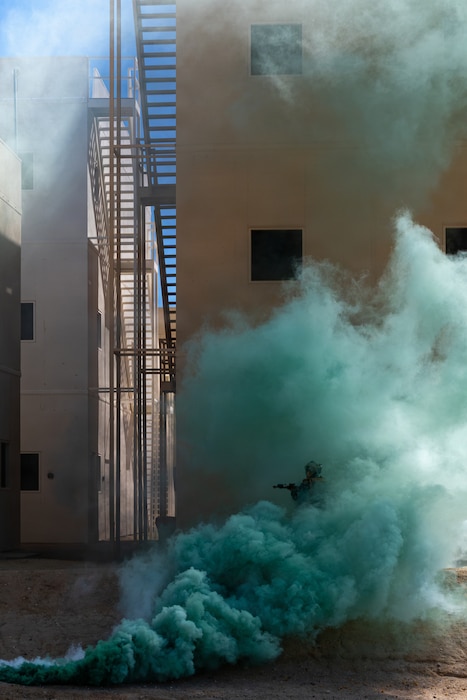 U.S. Marine with 2nd Battalion, 1st Marine Regiment, 1st Marine Division, advances through smoke during a company-level urban assault during Service Level Training Exercise 4-26 at Range 220, Marine Corps Air Ground Combat Center, Twentynine Palms, California, July 30, 2026. SLTE is a premier training event that ensures the Marine Corps remains a highly lethal, adaptable force capable of dominating the future multi-domain fight.  (U.S. Marine Corps photo by Sgt. Daniel Avilaramirez)