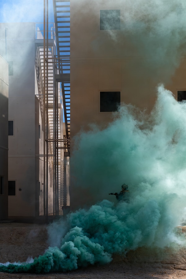 U.S. Marine with 2nd Battalion, 1st Marine Regiment, 1st Marine Division, advances through smoke during a company-level urban assault during Service Level Training Exercise 4-26 at Range 220, Marine Corps Air Ground Combat Center, Twentynine Palms, California, July 30, 2026. SLTE is a premier training event that ensures the Marine Corps remains a highly lethal, adaptable force capable of dominating the future multi-domain fight.  (U.S. Marine Corps photo by Sgt. Daniel Avilaramirez)
