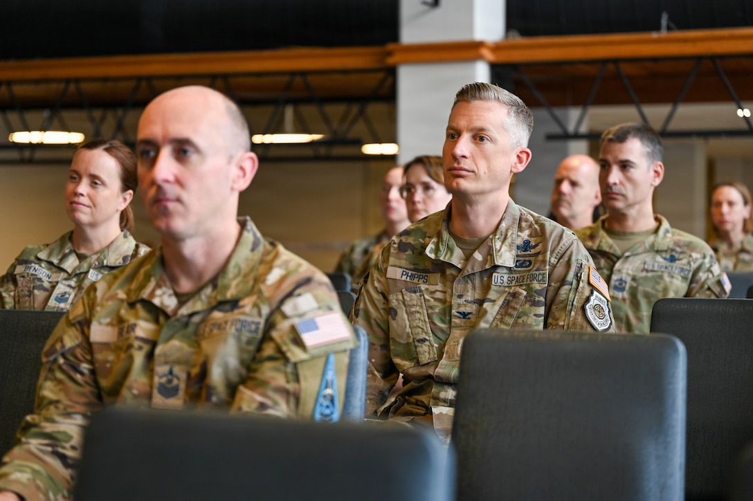 People in uniform at ceremony in building