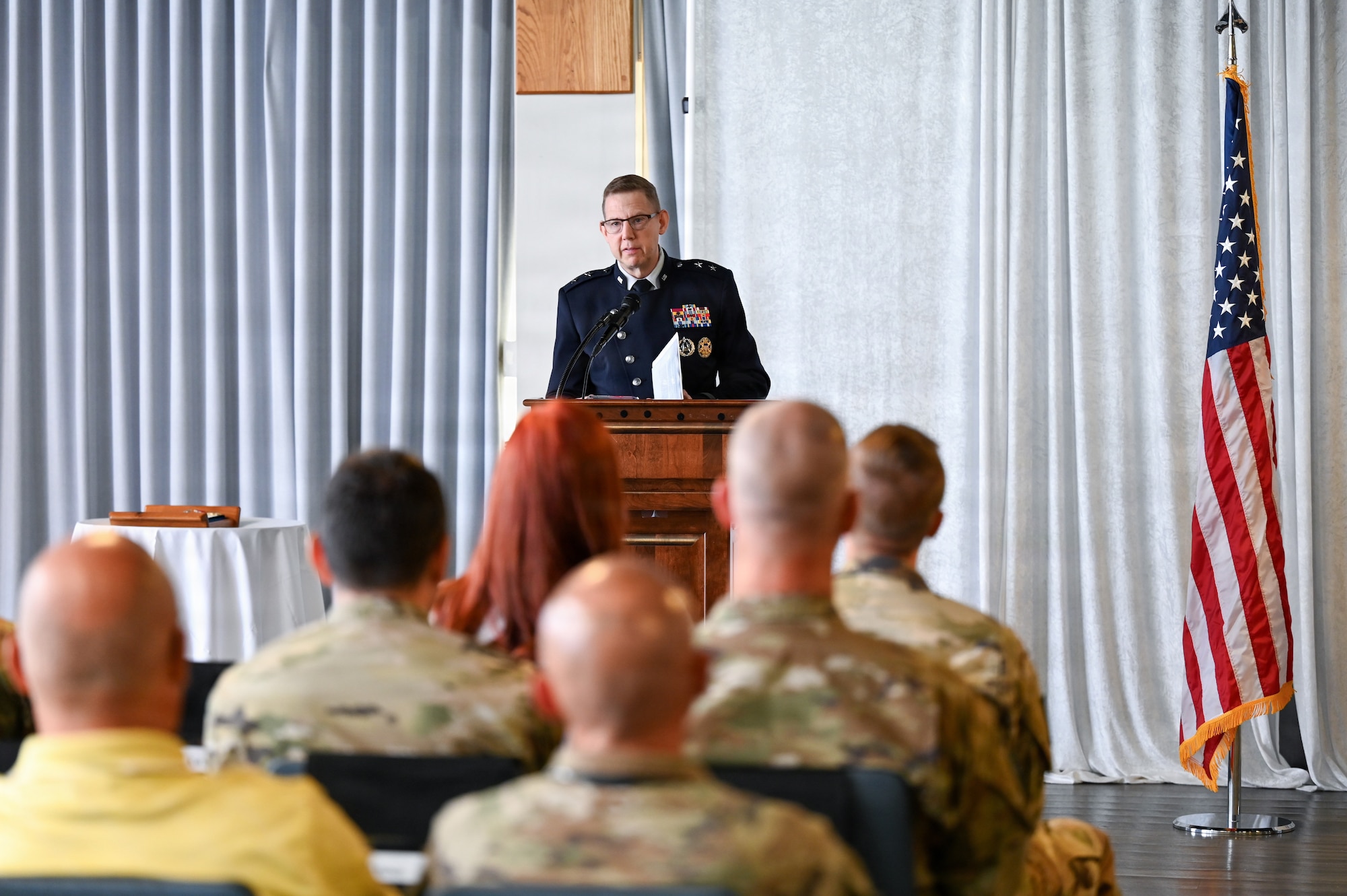 People in uniform at ceremony in building