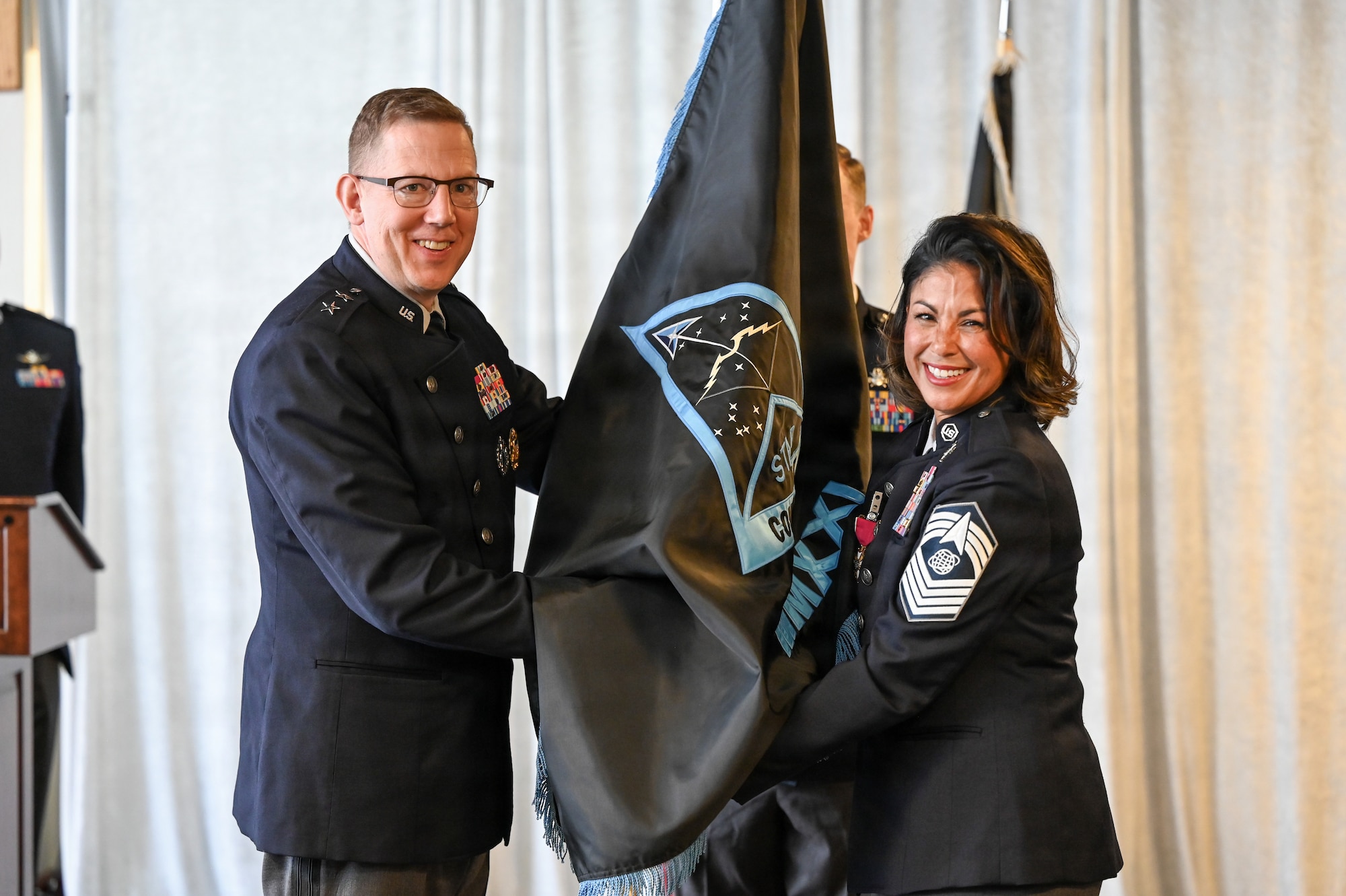 People in uniform at ceremony in building