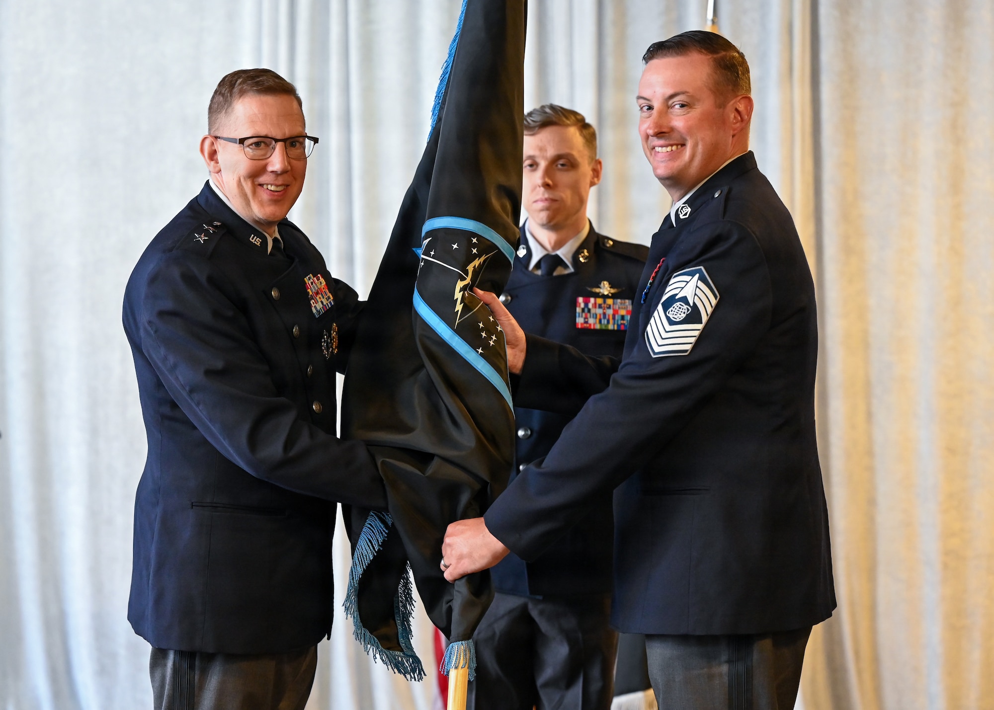 People in uniform at ceremony in building
